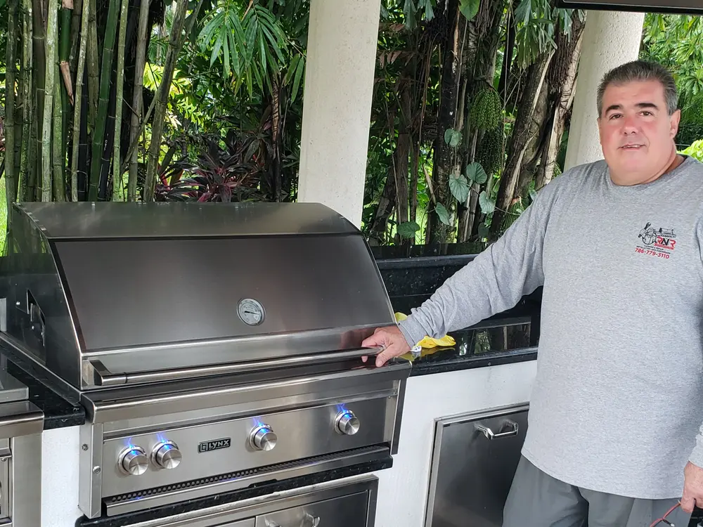 An RNR Appliances technician servicing a built-in grill at a South Florida home